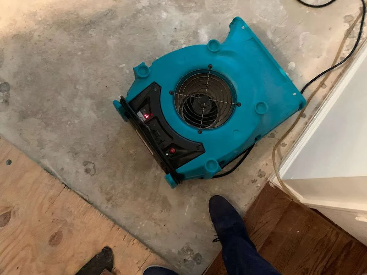 Air mover drying subfloor during Commercial Water Damage Restoration in Lake Butler